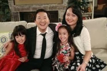 Tran Jeong with her spouse and twin daughters.